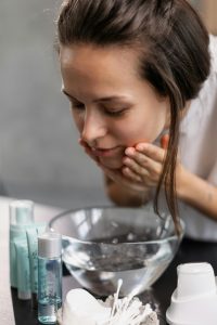 Facial steaming step in how to safely remove whiteheads at home